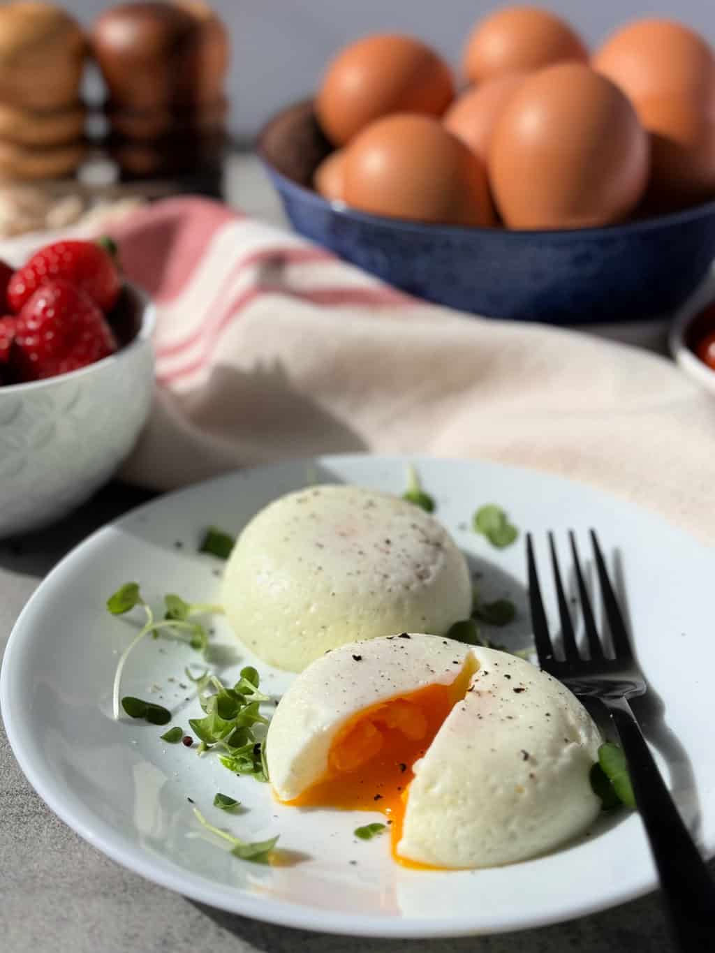 round poached egg on plate with slightly runny yolk
