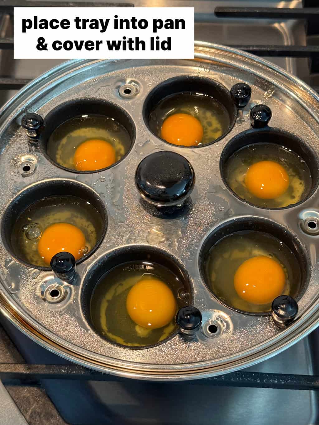 eggs in cups on stove in pan with clear glass lid