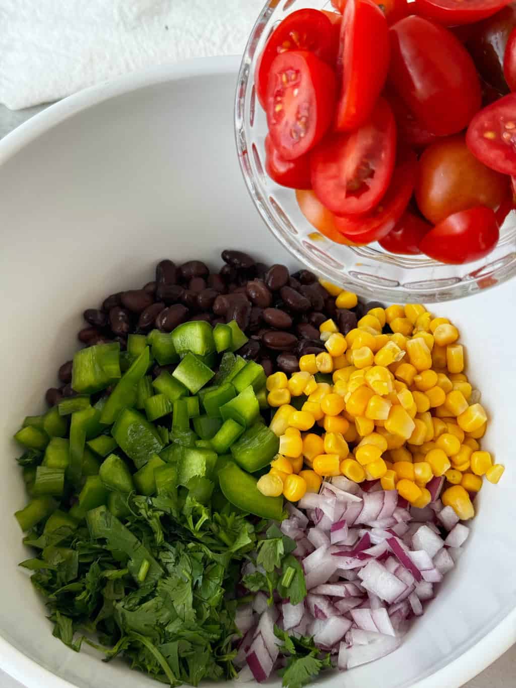 red sliced tomatoes adding into bowl