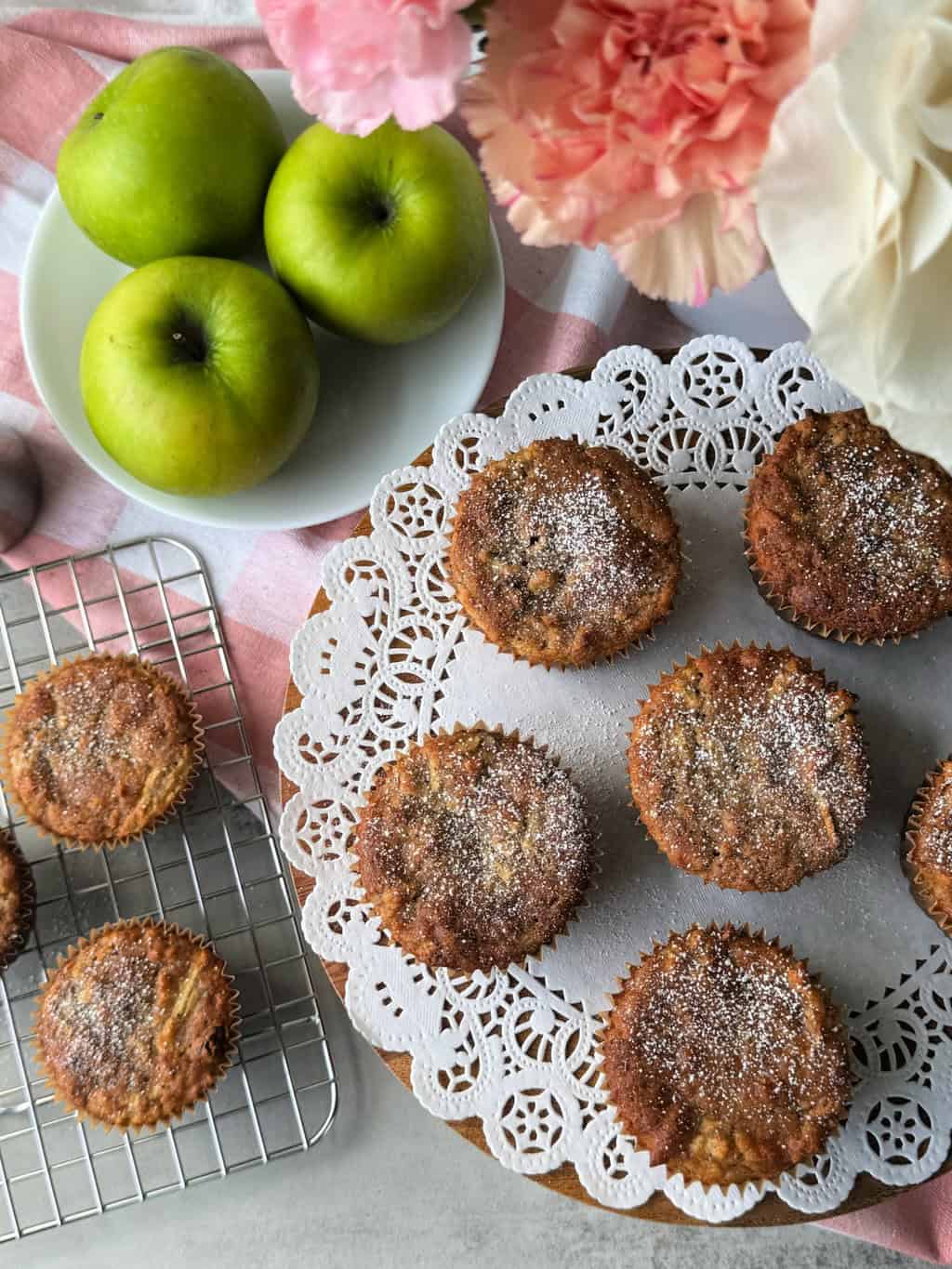 Healthy Apple Muffin Recipe with Raisins dusted with white powdered sugar and green granny smith apples in background